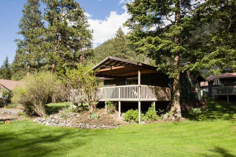Resort Cabin 5 has a nice covered deck that looks out on the river.